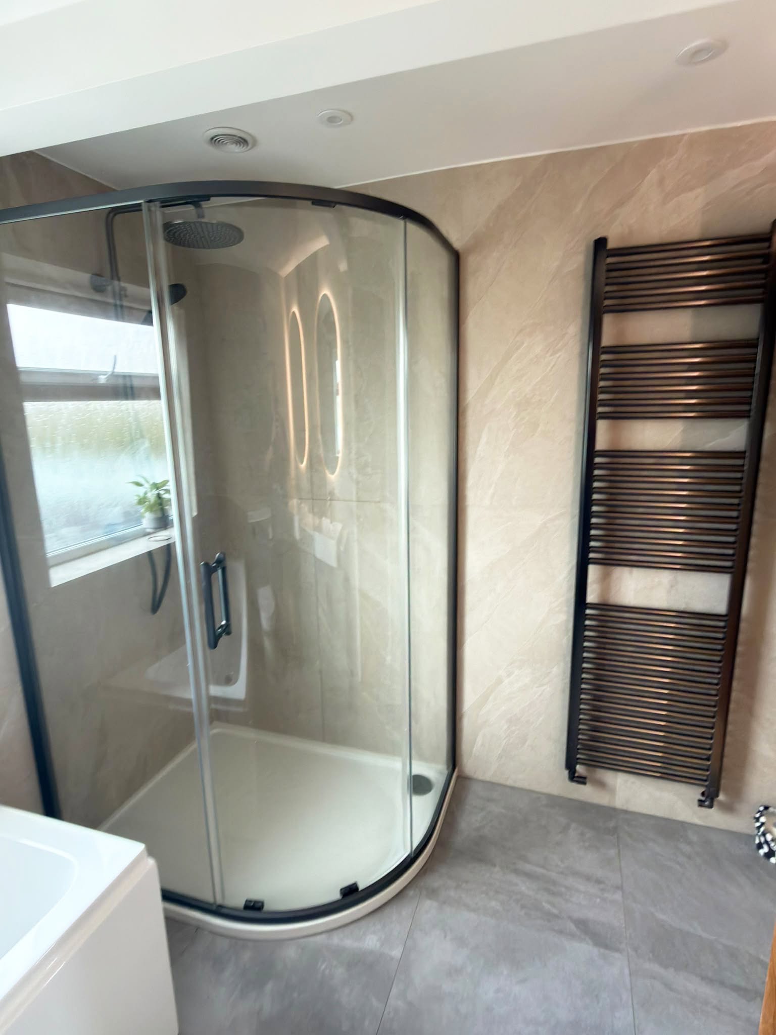 Quadrant shower enclosure with gun metal frame and towel warmer