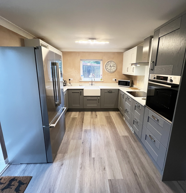 American fridge freezer beside grey shaker units