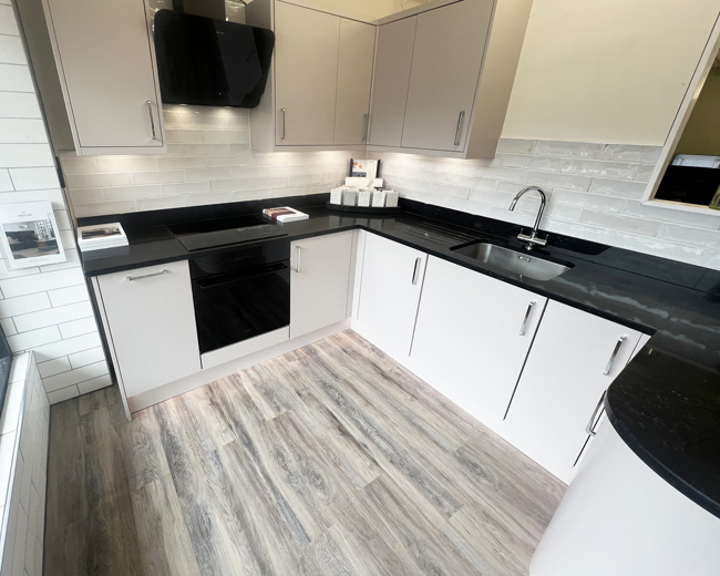 Matt Cashmere kitchen display with a black Corestone worktop
